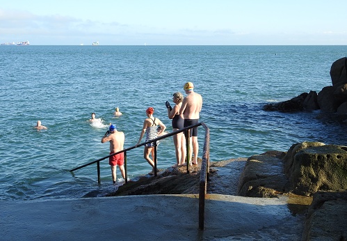 3rd March 2020, Dublin, Ireland. People at the Forty Foot free public outdoor ocean swimming area in Sandycove, County Dublin, where people have been swimming for 250 years.