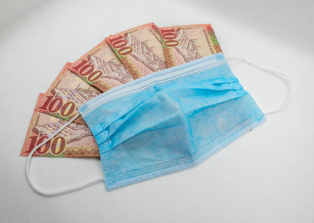 istock Saudi Arabian 100 Riyal bank note with surgical protective face mask 1213555690