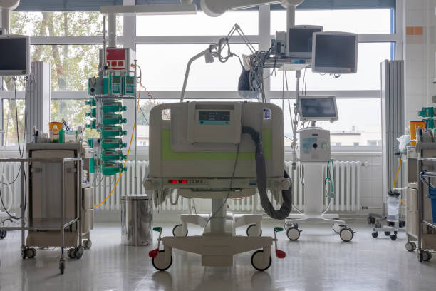 Intensive care unit in hospital, bed with monitors, ventilator, a place where can be  treated patients with pneumonia caused by coronavirus covid 19. stock photo