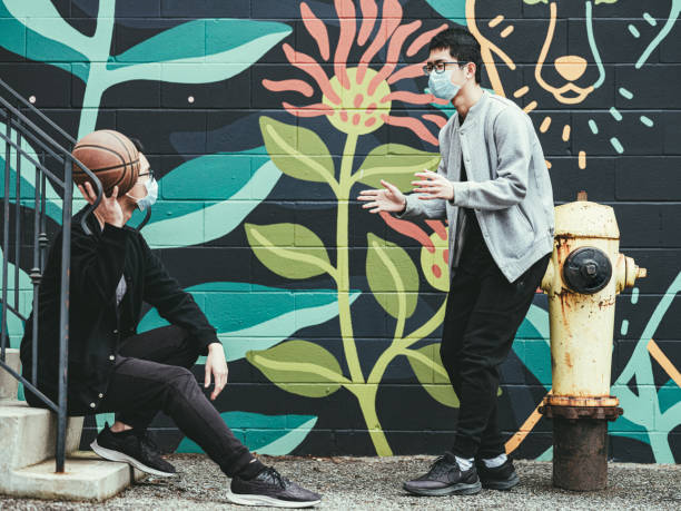 istock COVID-19, Teenagers passing b-ball outside 1213556949