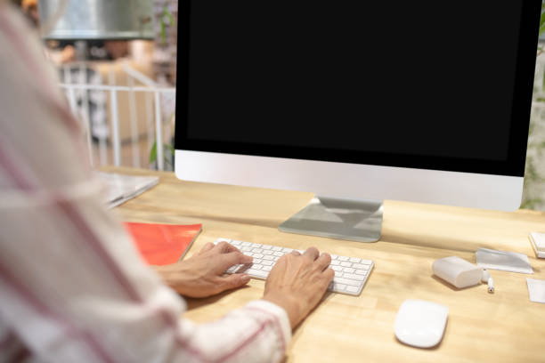 istock Female hands typing on keyboard in front of screen 1213557167