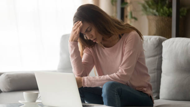 istock Tired stressed unhappy woman suffering from headache at home 1213557404
