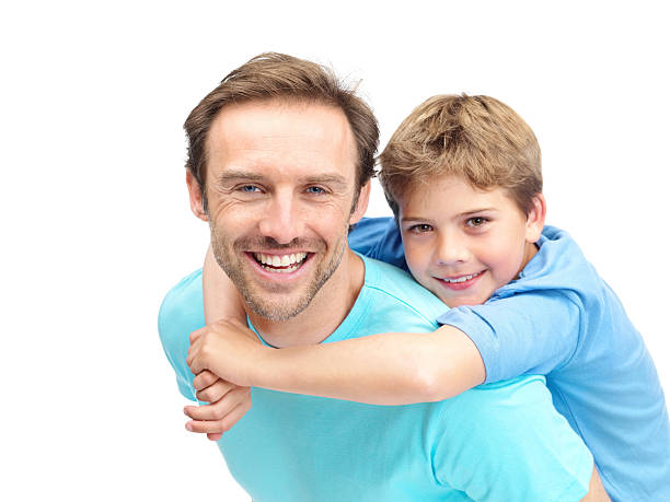 istock Smiling man giving his son a piggyback ride 121355834