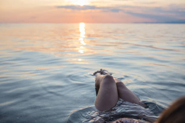 istock Young woman posing in the sea 1213558545