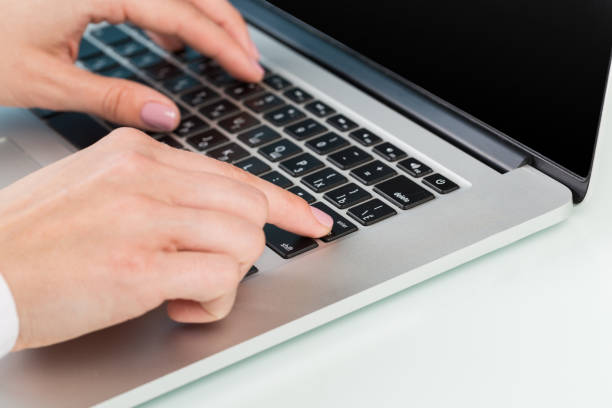 istock doctor's hand is typing the data into the system. Using a laptop computer.female hands in a medical white coat 1213561412