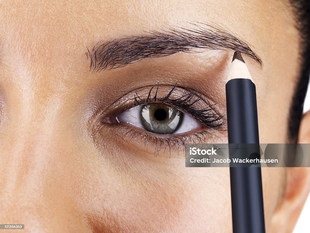 Attractive woman applying eyebrow pencil  Eyebrow Stock Photo