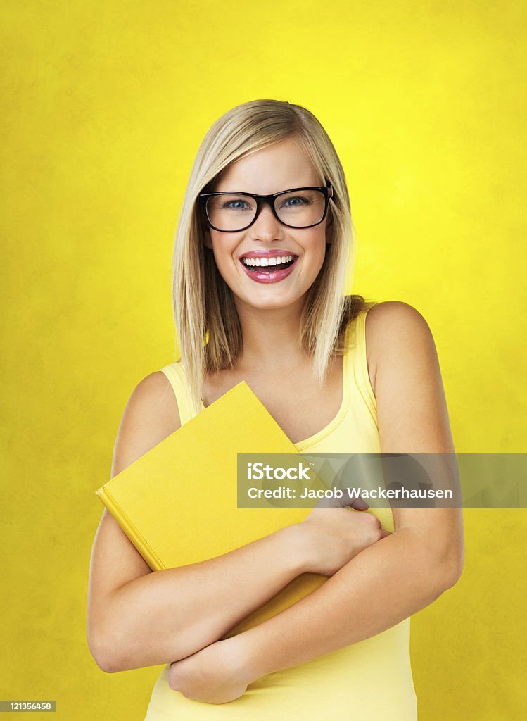 Happy young student holding book  20-29 Years Stock Photo