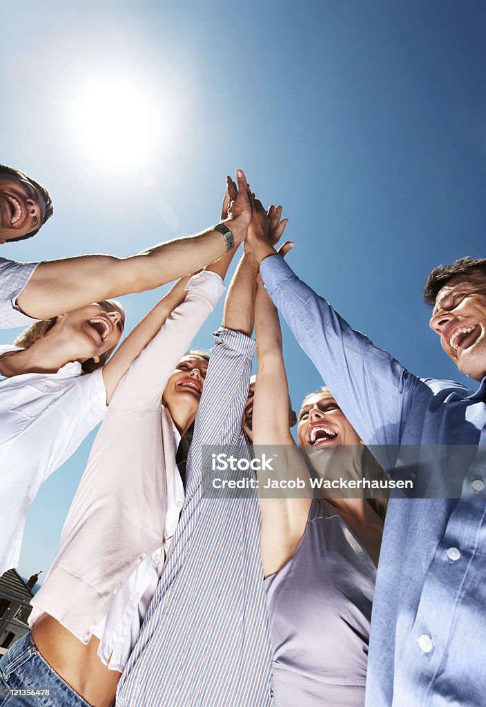 Joyful business people together celebrating their success  High-Five Stock Photo