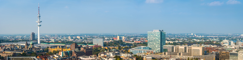 Aerial panorama over the iconic spire of the Heinrich Hertz Turm tv tower overlooking the rooftops of central Hamburg, Germany’s vibrant second city.