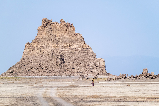 Africa, Djibouti, Lake Abbe. Landscape view of lake Abbe. Two people two people are standing down a rock formation