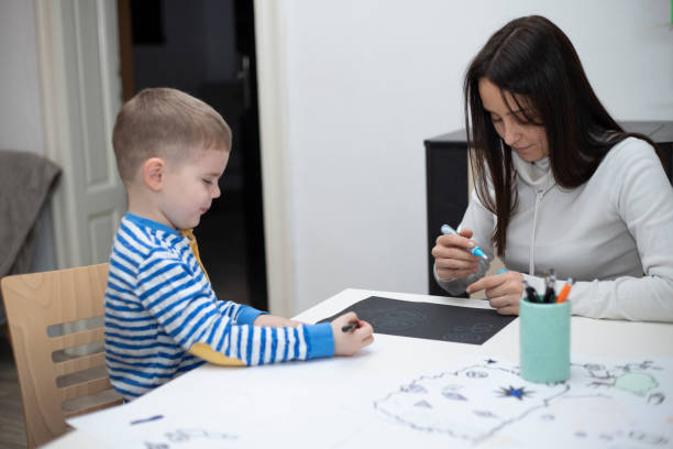 istock Child drawing with mother 1213566678