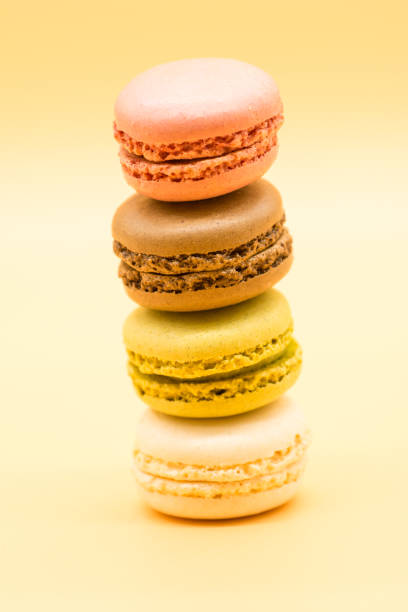 istock delicious various macarons stacked and some spread around on warm colored background 1213567307