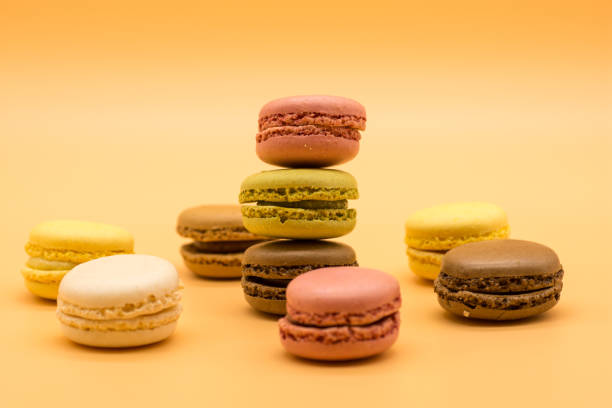 istock delicious various macarons stacked and some spread around on warm colored background 1213567316