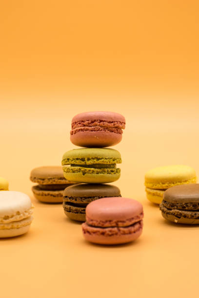 istock delicious macarons full and bitten arranged on colored background 1213567355