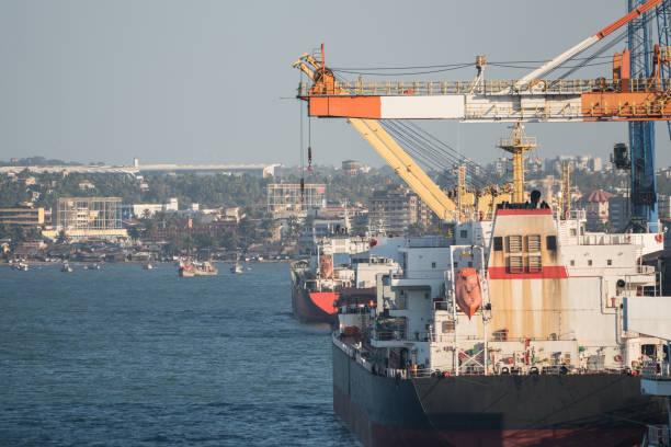 Container ship and cranes for unloading and loading in the seaport, Gulf of La Spezia, Liguria, Italy, Europe