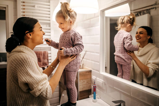 istock Mother and daughter playing with lipctick 1213573521