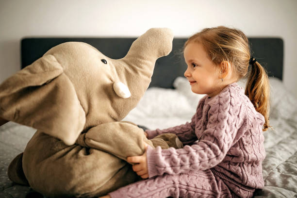 Cute girl playing with toy in bedroom