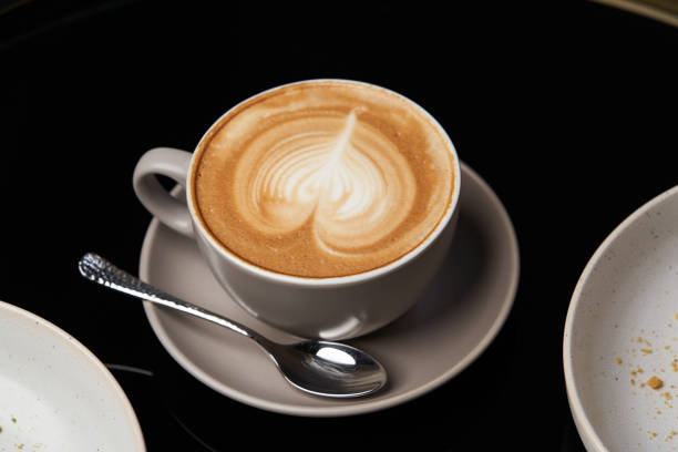 istock Cappuccino coffee cup and cake on plate on table, close-up. 1213573932