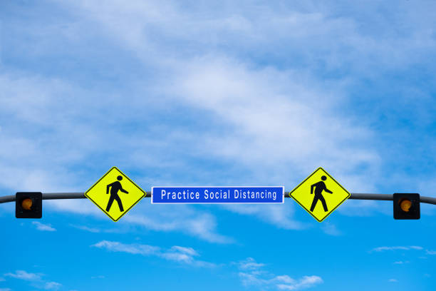 Conceptual digital composite - Road signs telling people to practice social distancing and to stay 6 feet apart. These signs are in response to the covid-19 pandemic.