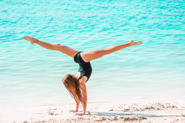 istock Adorable active little girl at beach during summer vacation 1213576113