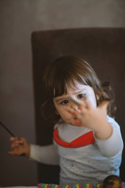 istock Little girl painting 1213578040