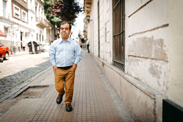 istock Dwarf man walking on city street 1213579010