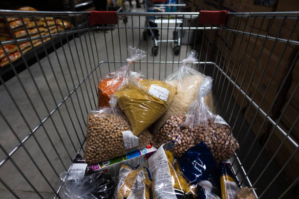 Supermarket Trolley fulfilled with legumes for food supply to survive quarantine days stock photo