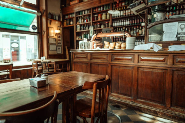 Table of traditional Parisian outdoor cafe. Cup of coffee and pitcher with dried flowers in empty restaurant in Paris, France
