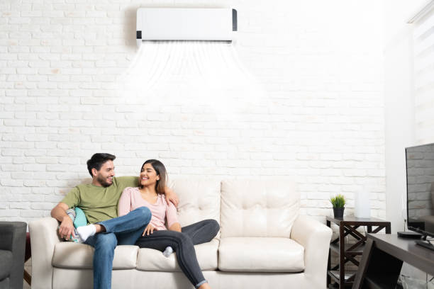 Smiling Hispanic Couple Relaxing At Home