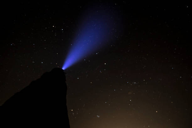 istock Side View of Unrecognizable Person Looking at Stars With Headlight 1213581274