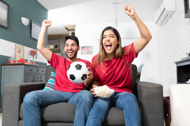 istock Couple Watching Soccer Match At Home 1213581301
