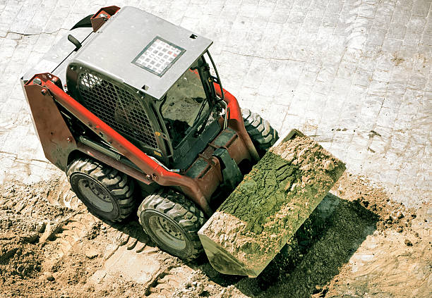 Small excavator on street stock photo