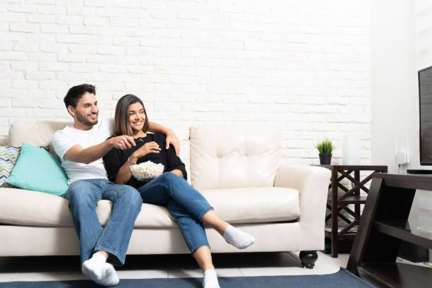istock Happy Couple Is Watching TV At Home 1213581421