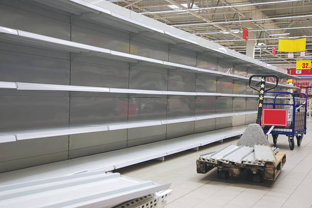 istock Empty shelves and cart in grosery store 1213581652
