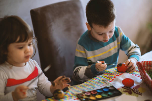 istock Children painting Easter eggs at home 1213582677