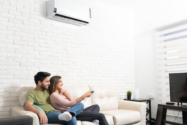 istock Latin Couple Watching TV At Home 1213583502