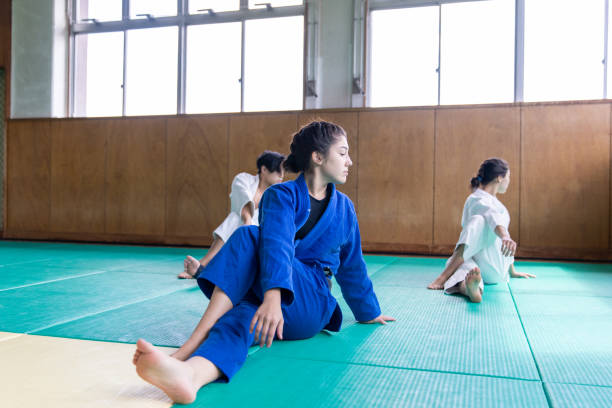 istock Three Judo athletes stretching in Dojo 1213583882