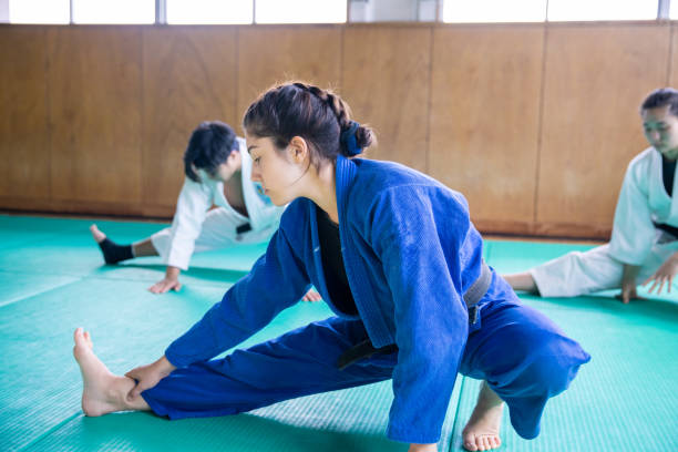 istock Young Judo athlete stretching in Dojo 1213583908
