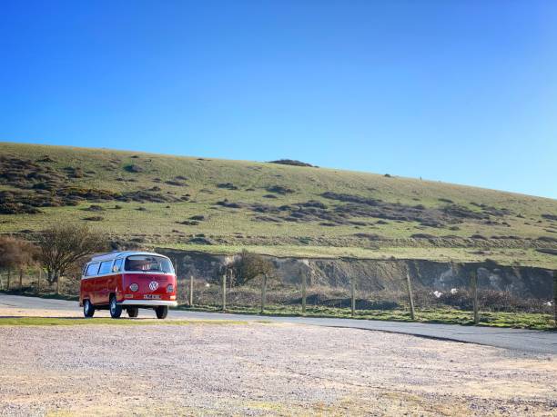 Volkswagen T2 campervan Alum Bay, Isle of Wight, England - March 16, 2020: A red Volkswagen T2 Campervan parks at an empty car park at The Needles Landmark Attraction during Coronavirus pandemic car rental covid stock pictures, royalty-free photos & images