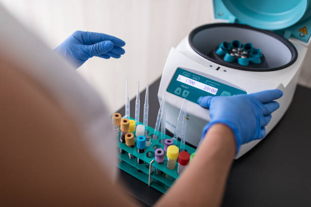 nurse in a lab carrying out a blood test amid deadly virus pandemic - aging process middle women men imagens e fotografias de stock