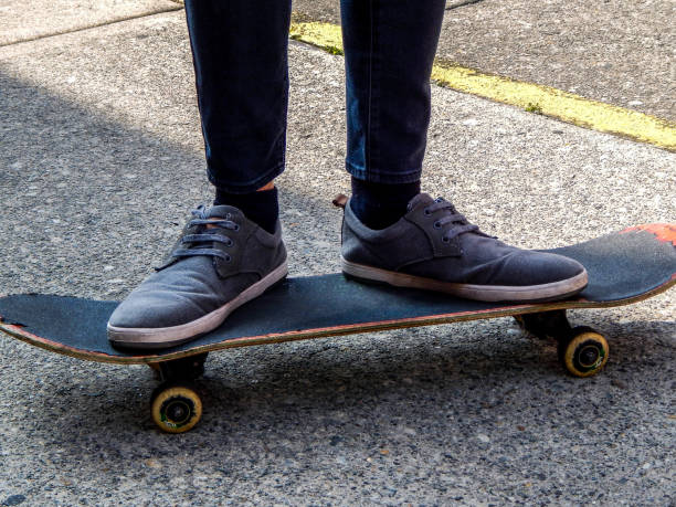 istock Young man standing on a skateboard on the pavement 1213586424