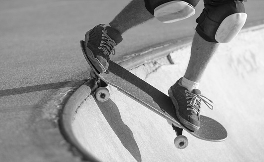 Skateboard photographed dropping into a bowl.