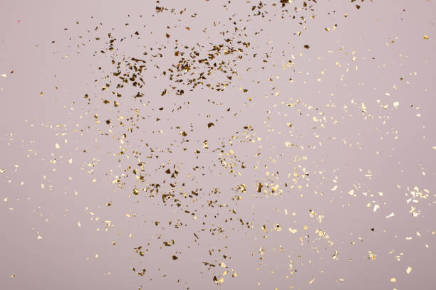 istock Golden flying sparkles on grey holiday background. 1213586480