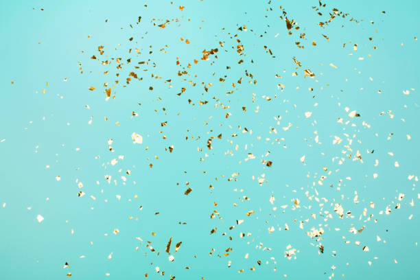 Golden flying sparkles on blue holiday background.