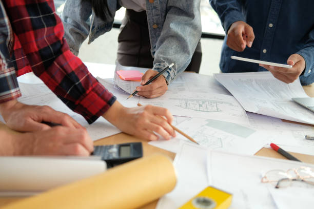 istock architect engineer team working discussing on house blueprint of real estate project in meeting 1213589926