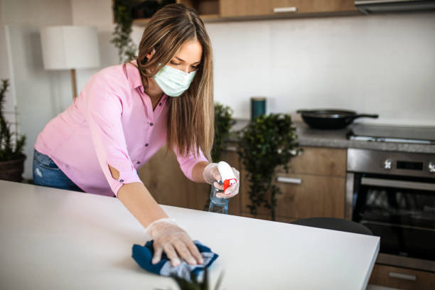 istock Young woman wiping kitchen counter 1213591035