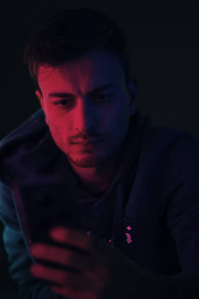 istock Young male looking at camera in an artificially illuminated environment 1213591166