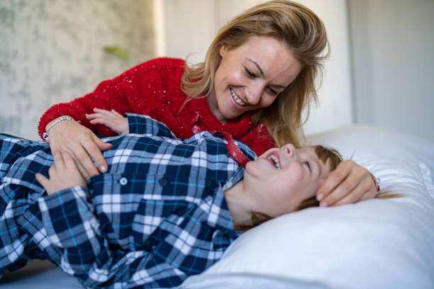 istock Mom caresses her son in bed 1213592015