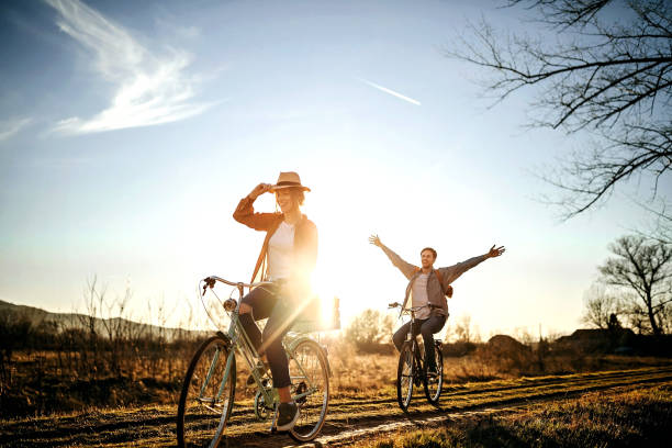 Sky is the limit for us Couple driving on bicycle in nature, enjoying the sun recreation stock pictures, royalty-free photos & images