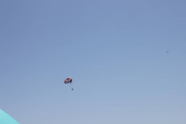 Parasailing Parasailing in the blue sky in Miami Beach. miami parachuting stock pictures, royalty-free photos & images